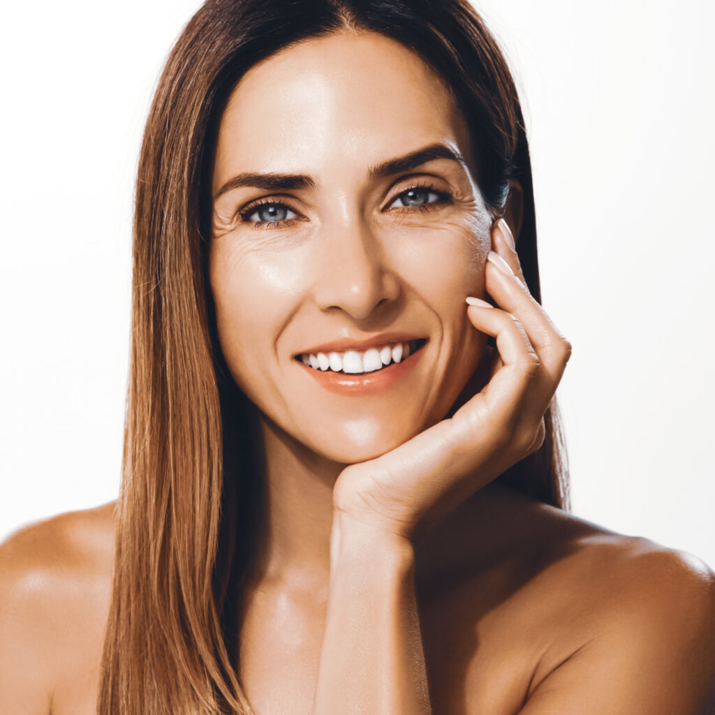 Smiling woman with smooth, refreshed skin showcasing natural-looking results from Juvéderm dermal filler treatment