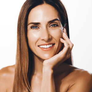 Smiling woman with smooth, refreshed skin showcasing natural-looking results from Juvéderm dermal filler treatment