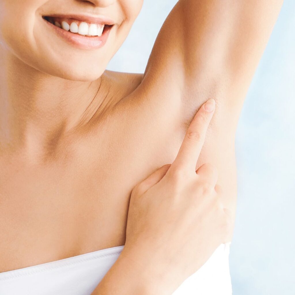 Woman pointing to Underarm - Laser Hair Removal