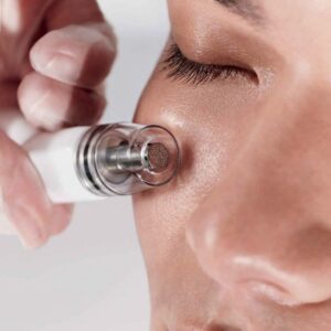white women getting diamond glow treatment on her face